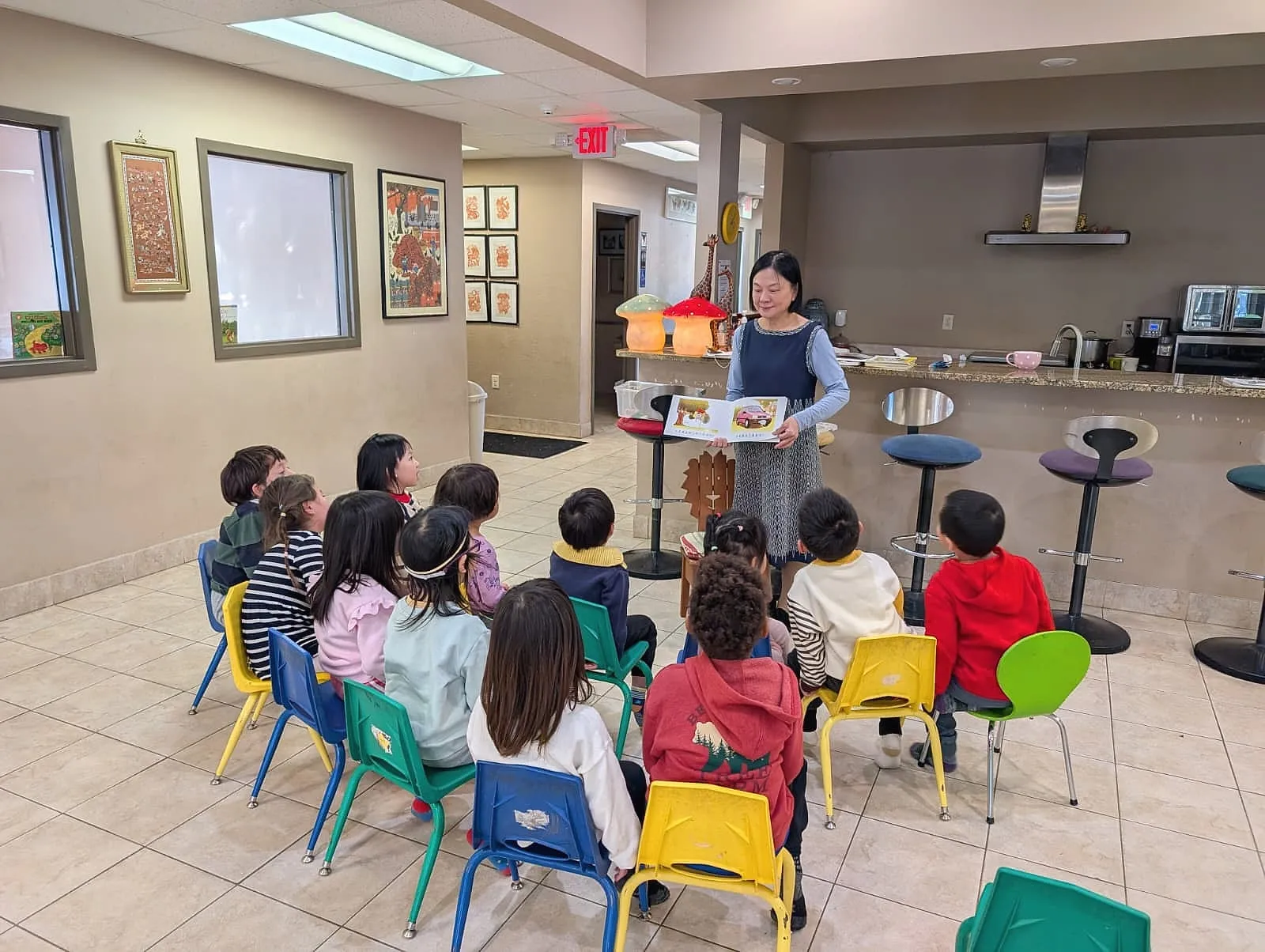 A teacher reading a picture book aloud to preschoolers at Einstein School in Madison